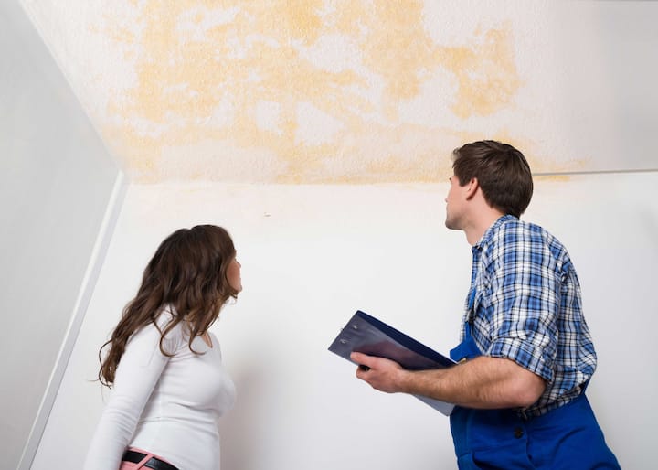 Water-Damage-Leak A water damage expert doing an assessment and inspection with a woman who has damaged ceiling caused by a water leak in King of Prussia